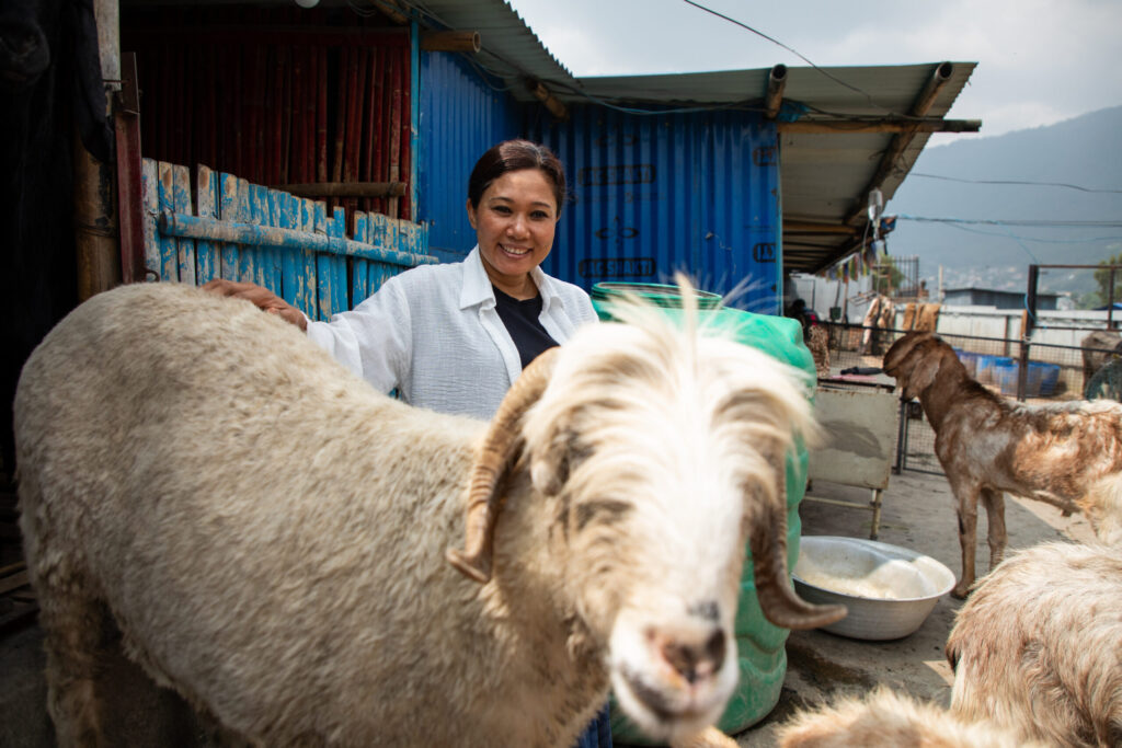 Sneha's Care owner Sneha Shrestha lets a goat out of its pen on May 15, 2026, at Sneha's Care outside of Kathmandu, Nepal. Photo by Henry Doelinger.